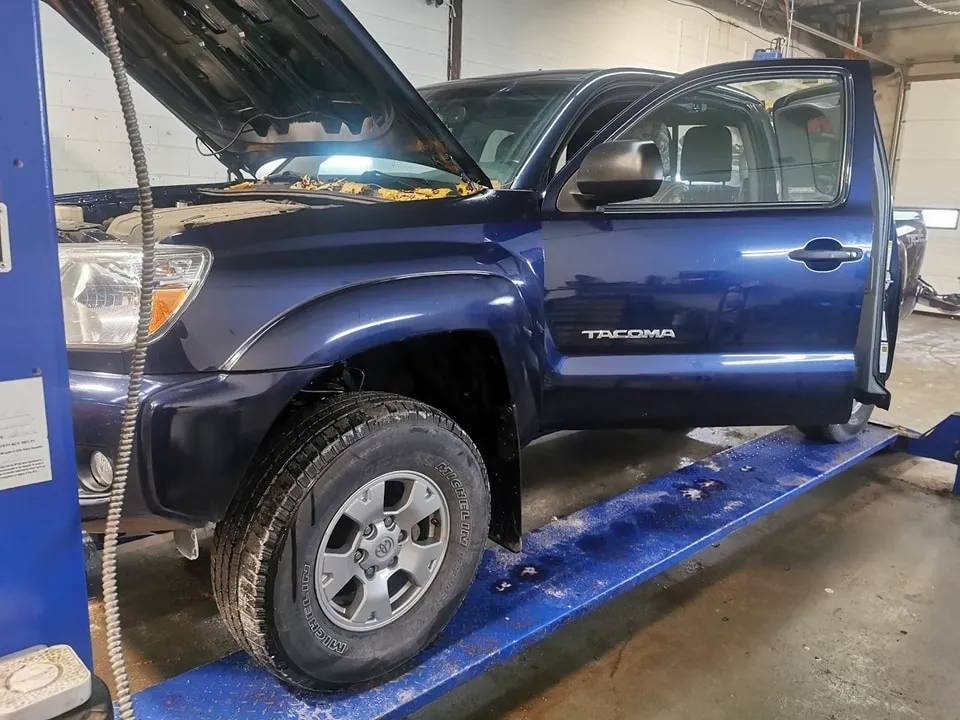blue Toyota Tacoma on hoist for rust check service at Ultimate Detail Bowmanville
